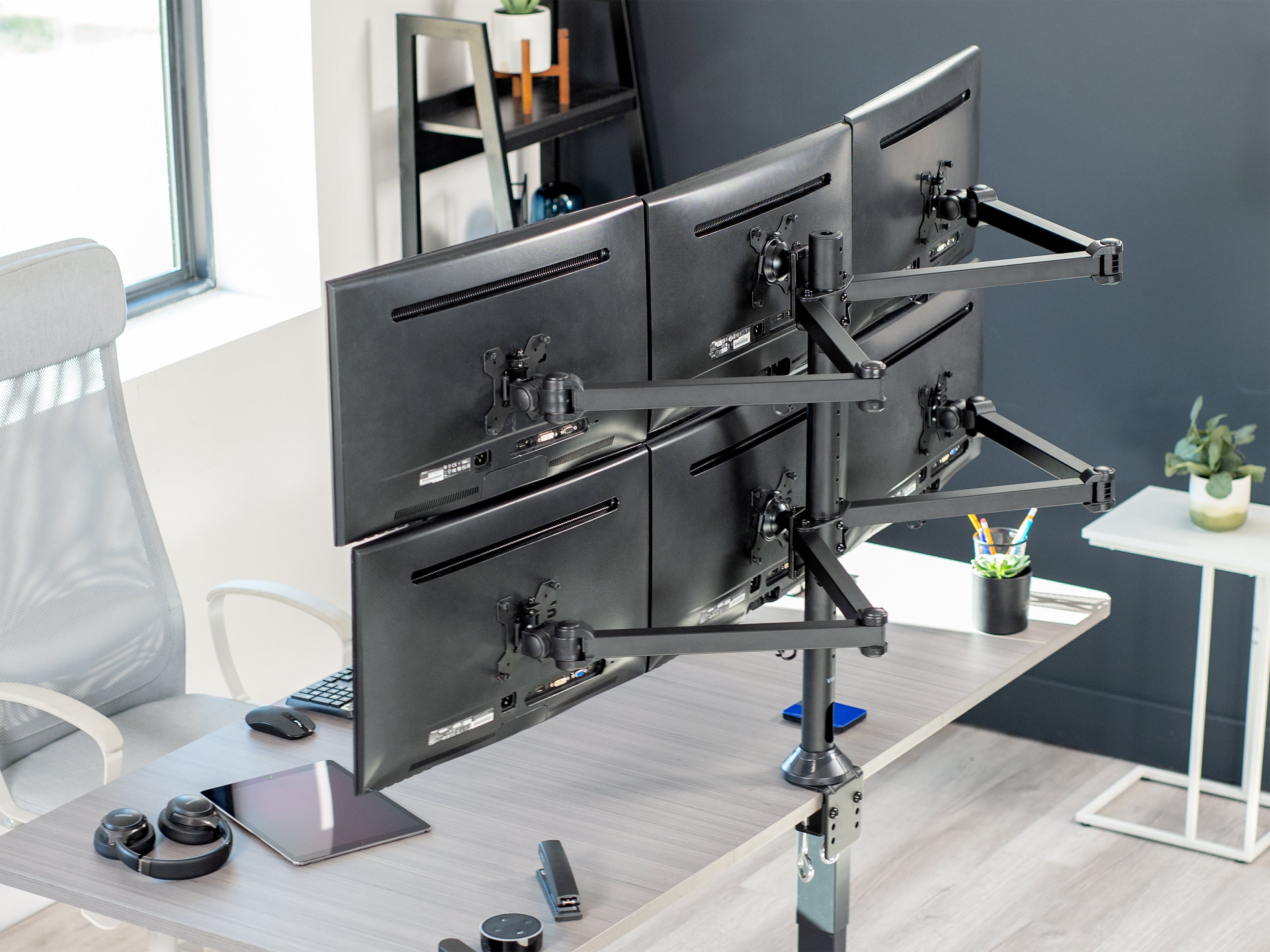 hex monitor stand on grey desk in office setting