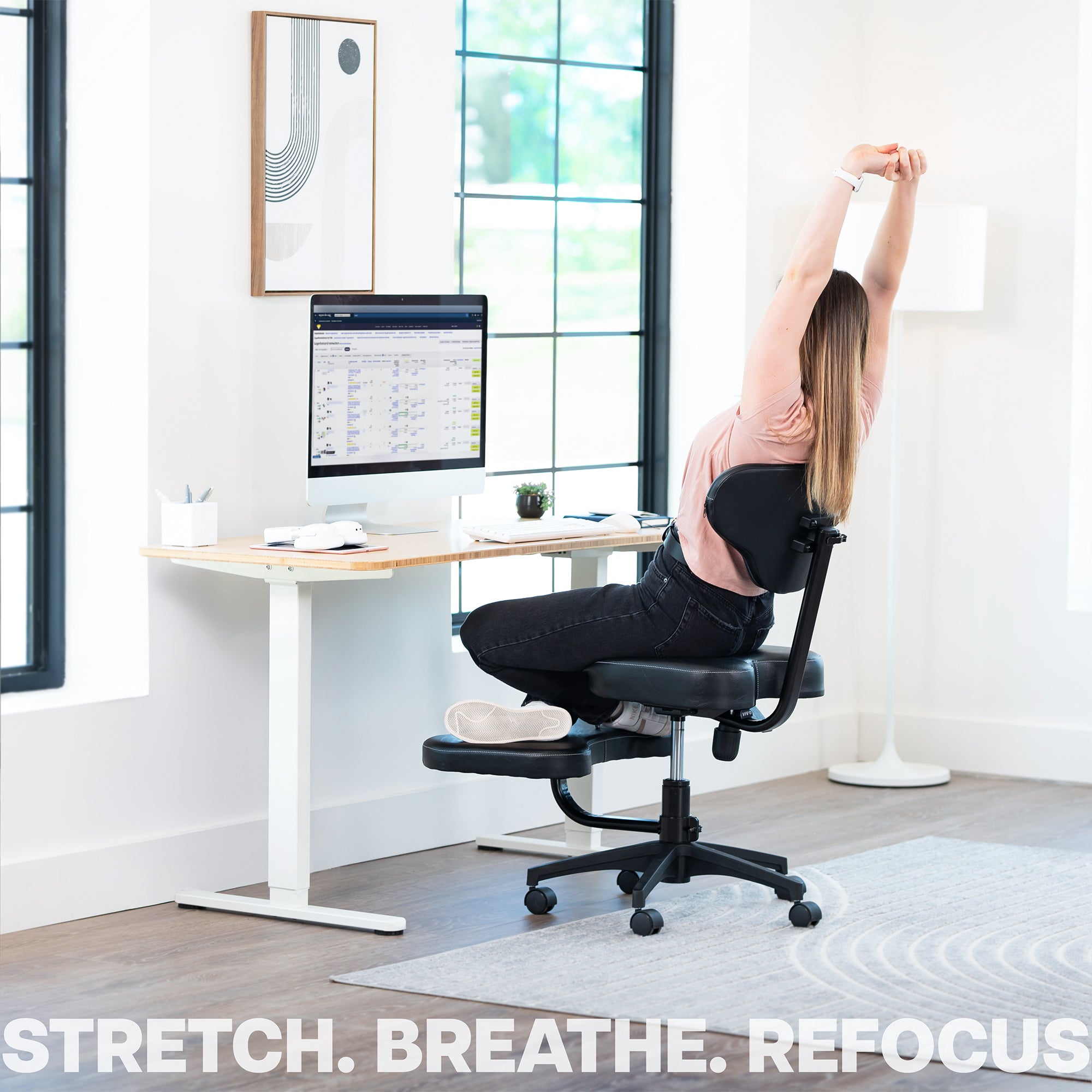 Person stretching on an ergonomic chair in a home office setting
