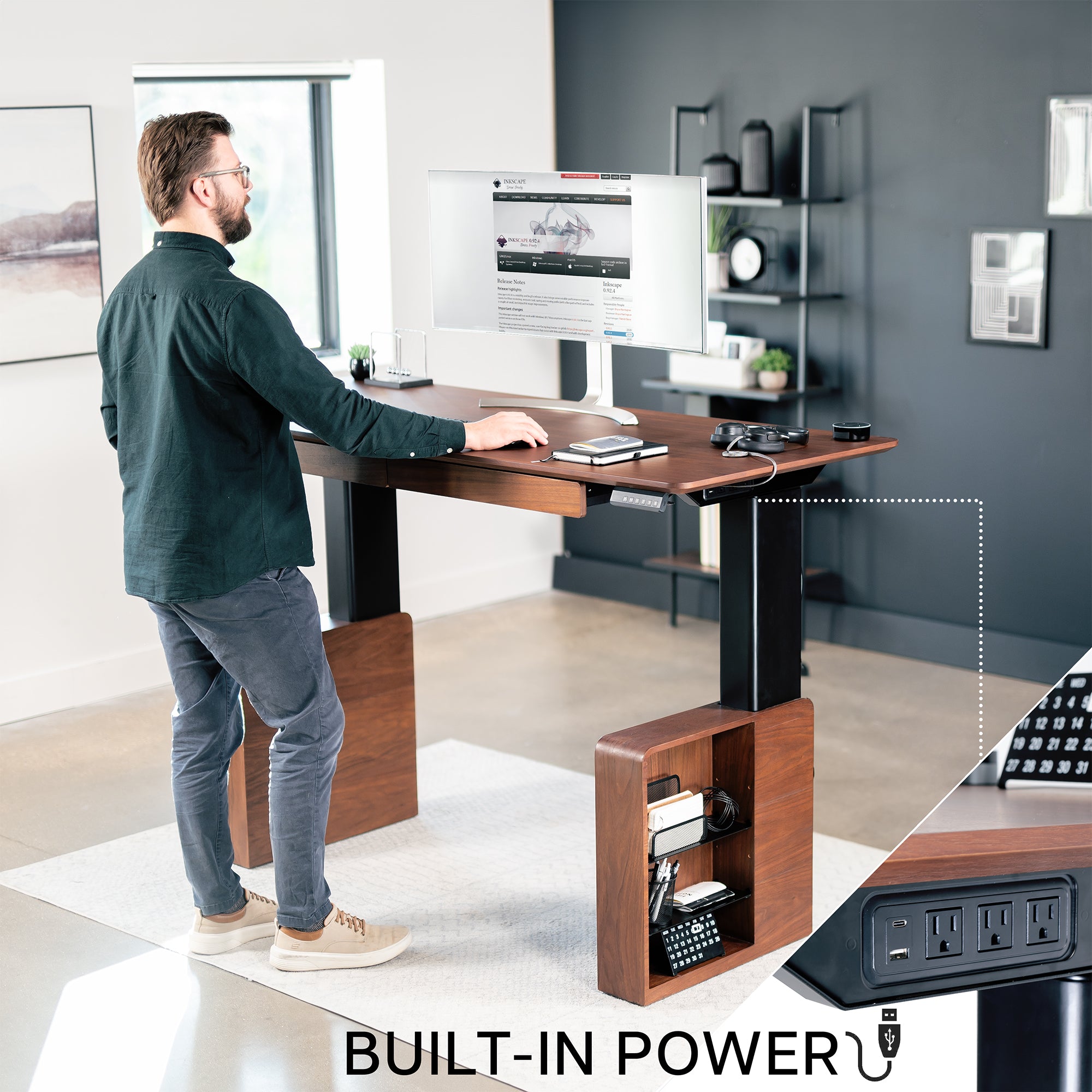 Spacious sit to stand walnut executive desk with two pull-out drawers, adjustable shelving on the reversible legs, and a built-in power strip for convenient connectivity.