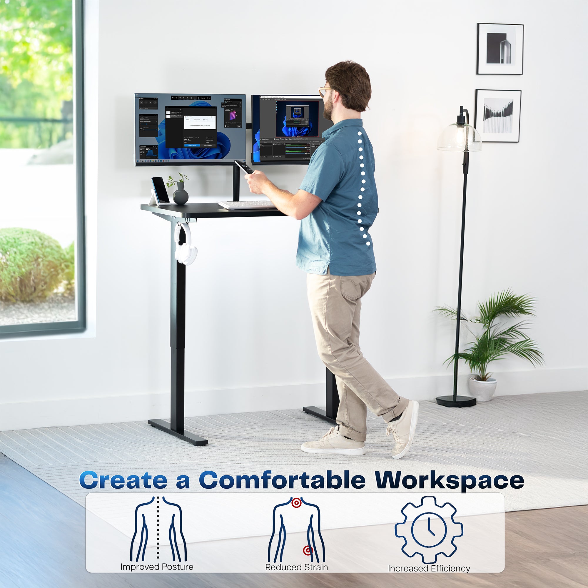 Model standing at height adjustable desk in office space.