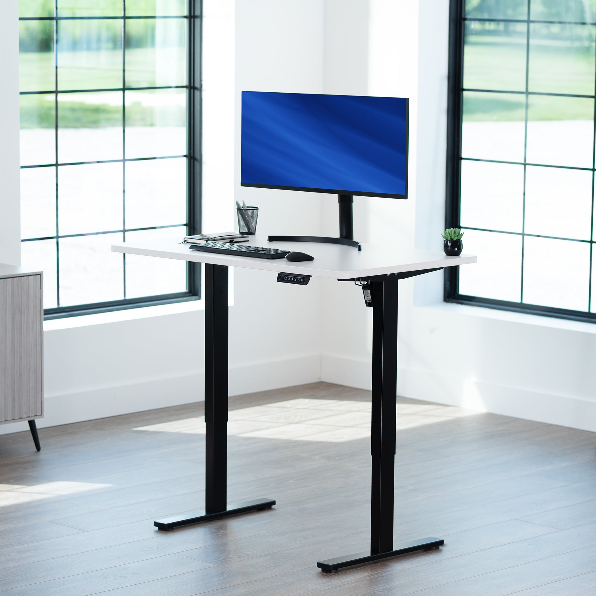 Sturdy ergonomic sit or stand active desk workstation with adjustable height using smart control panel.
