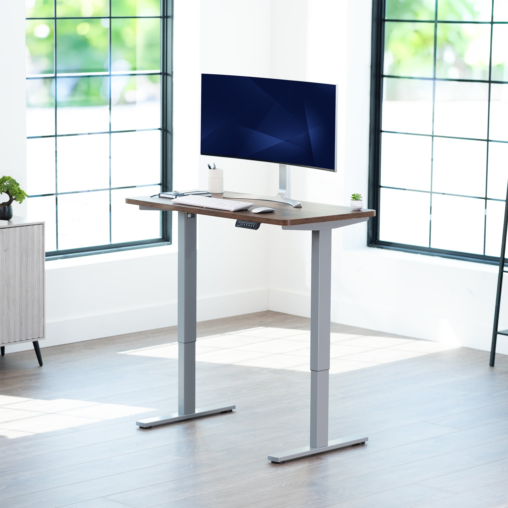 Sturdy ergonomic sit or stand active desk workstation with adjustable height using smart control panel.