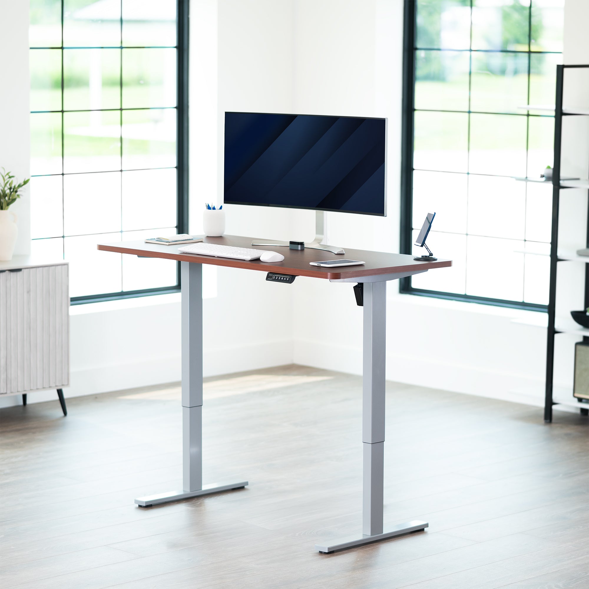 Sturdy ergonomic sit or stand active desk workstation with adjustable height using smart control panel.