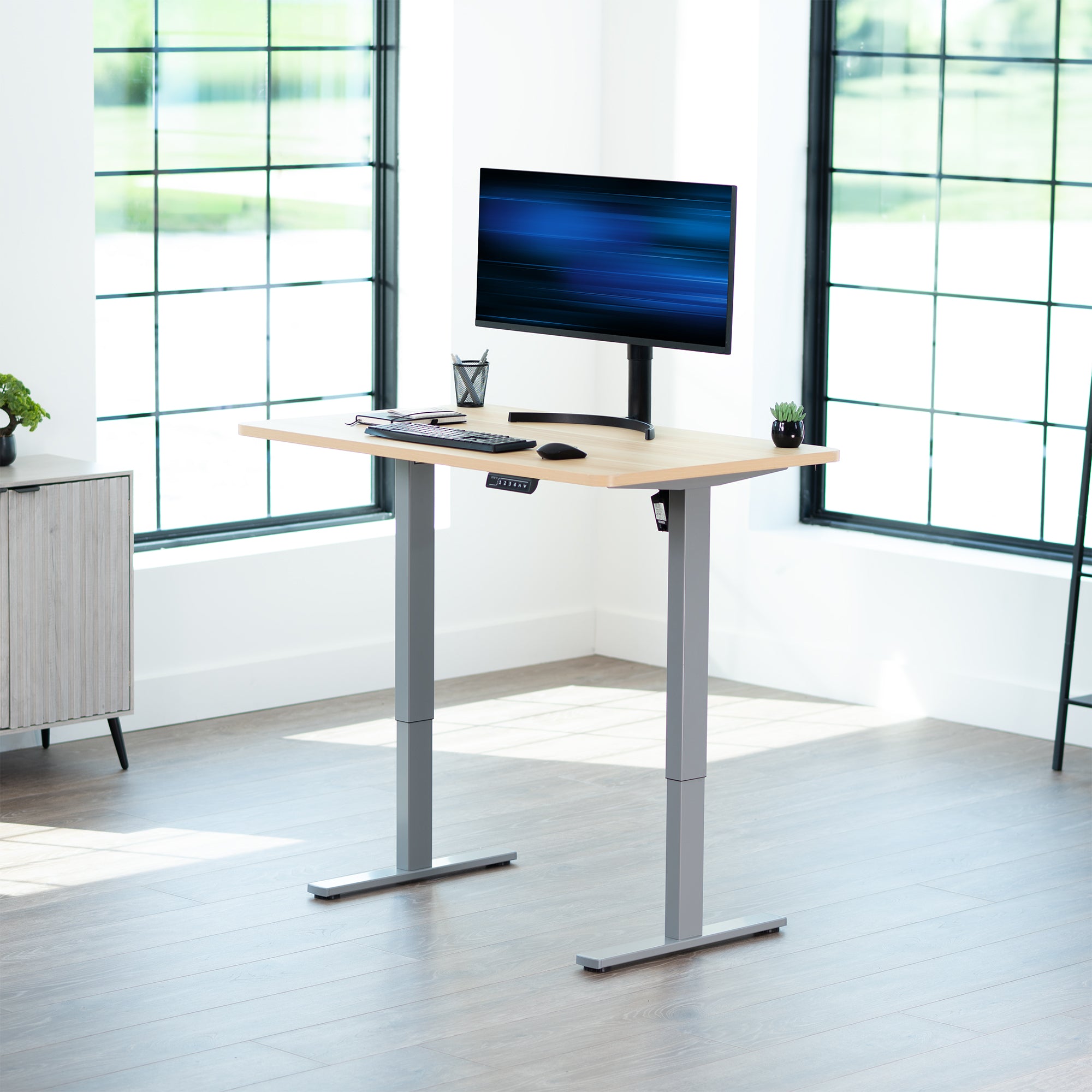 Sturdy ergonomic sit or stand active desk workstation with adjustable height using smart control panel.