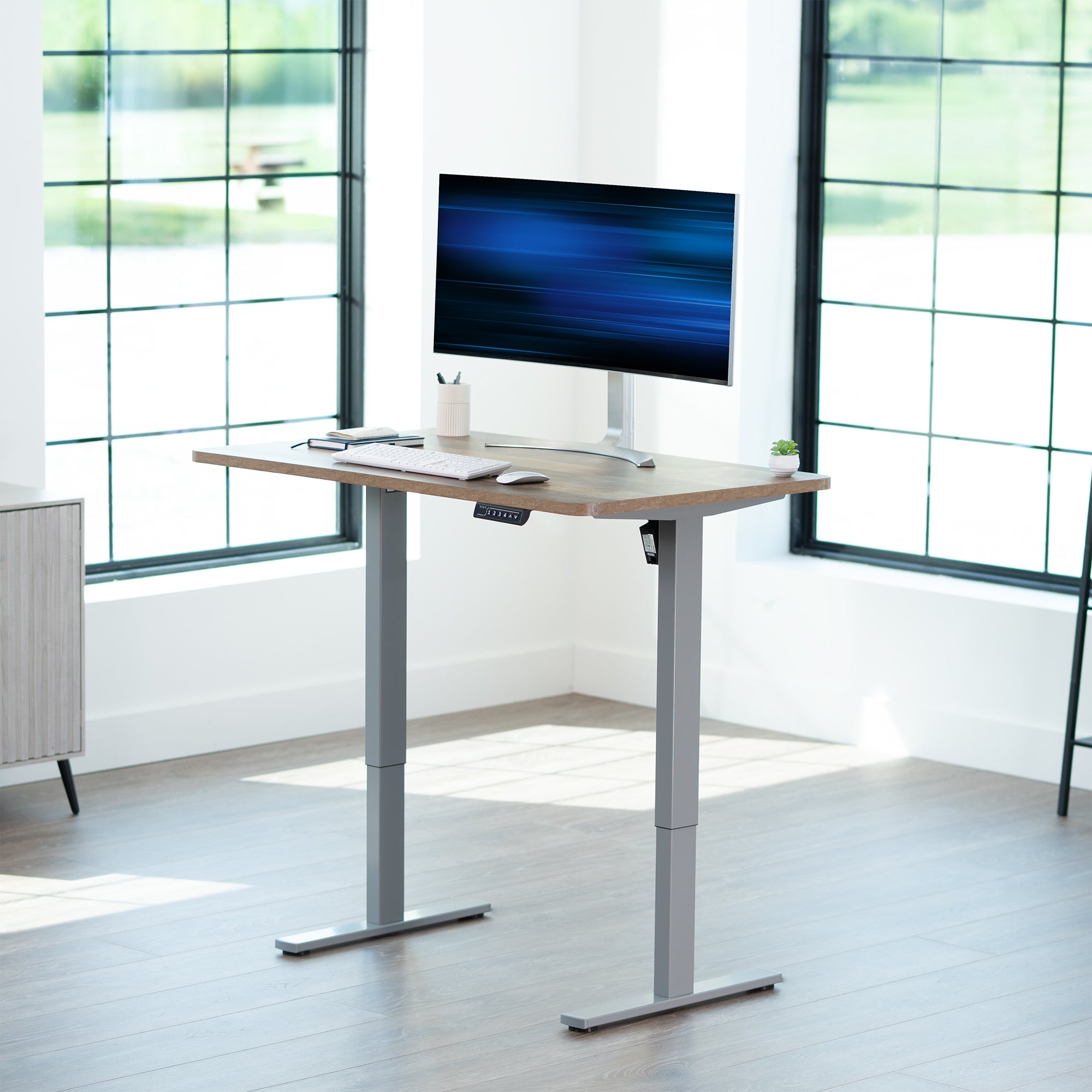 Sturdy ergonomic sit or stand active desk workstation with adjustable height using smart control panel.