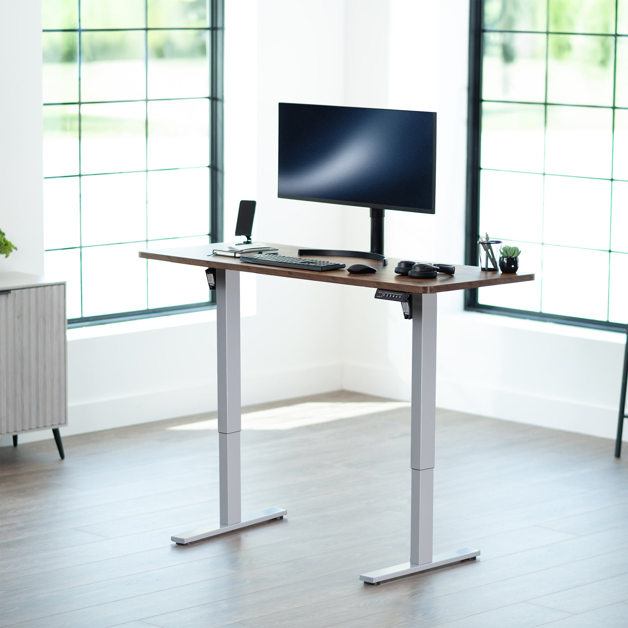Sturdy ergonomic sit or stand active desk workstation with adjustable height using smart control panel.