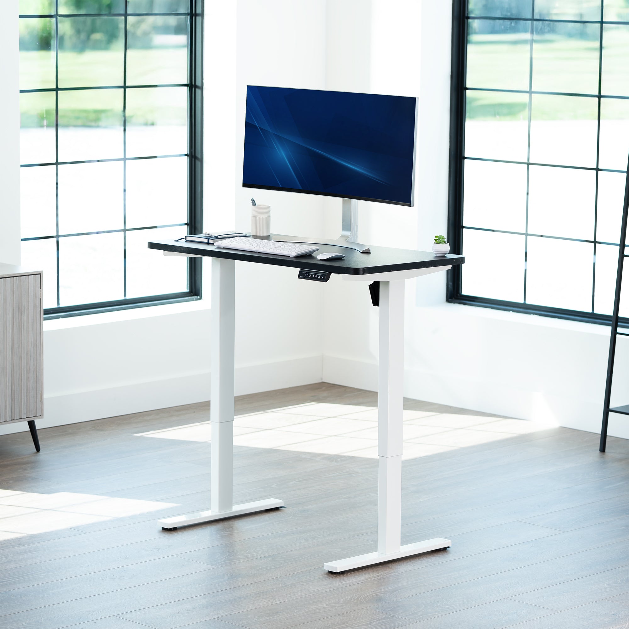 Sturdy ergonomic sit or stand active desk workstation with adjustable height using smart control panel.