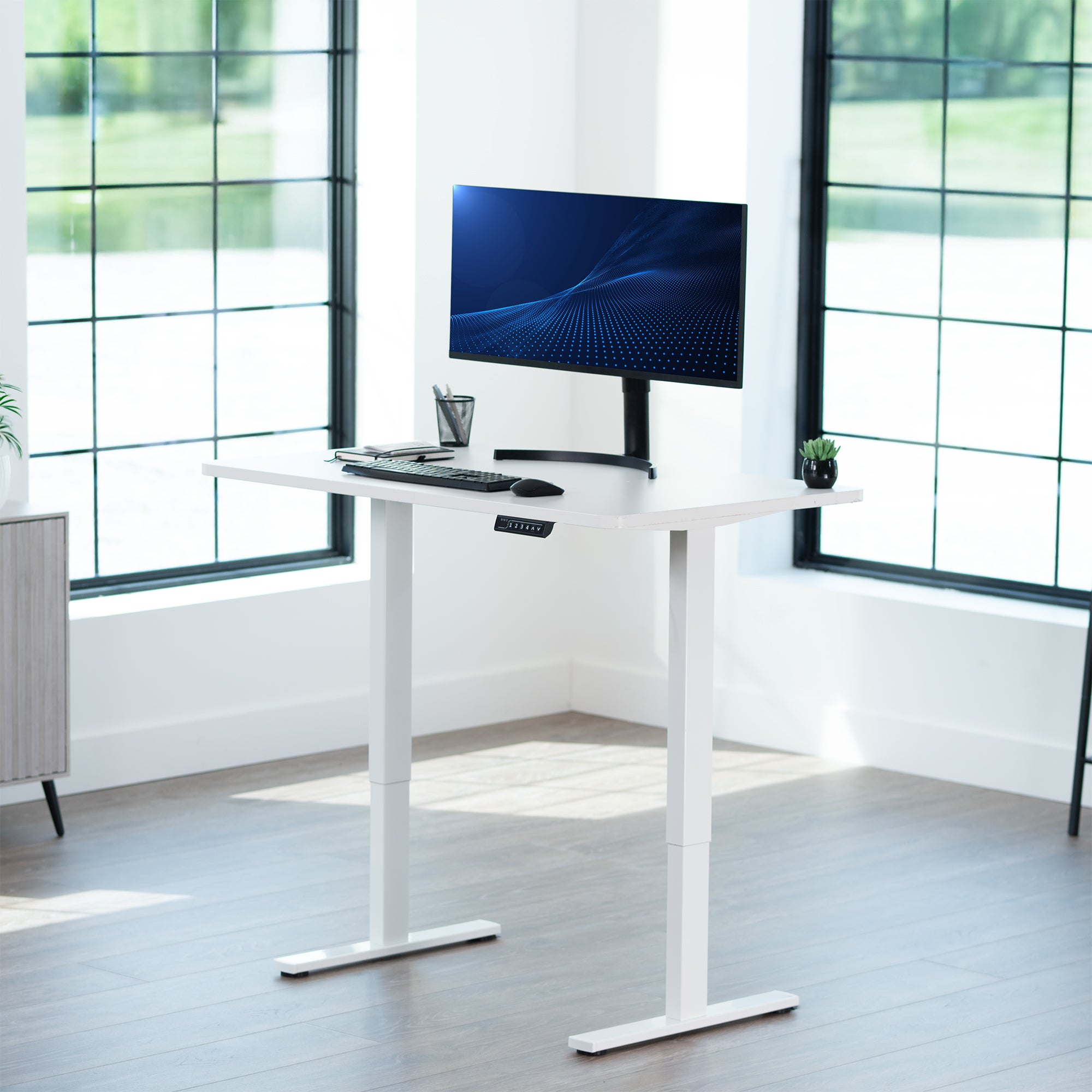Sturdy ergonomic sit or stand active desk workstation with adjustable height using smart control panel.