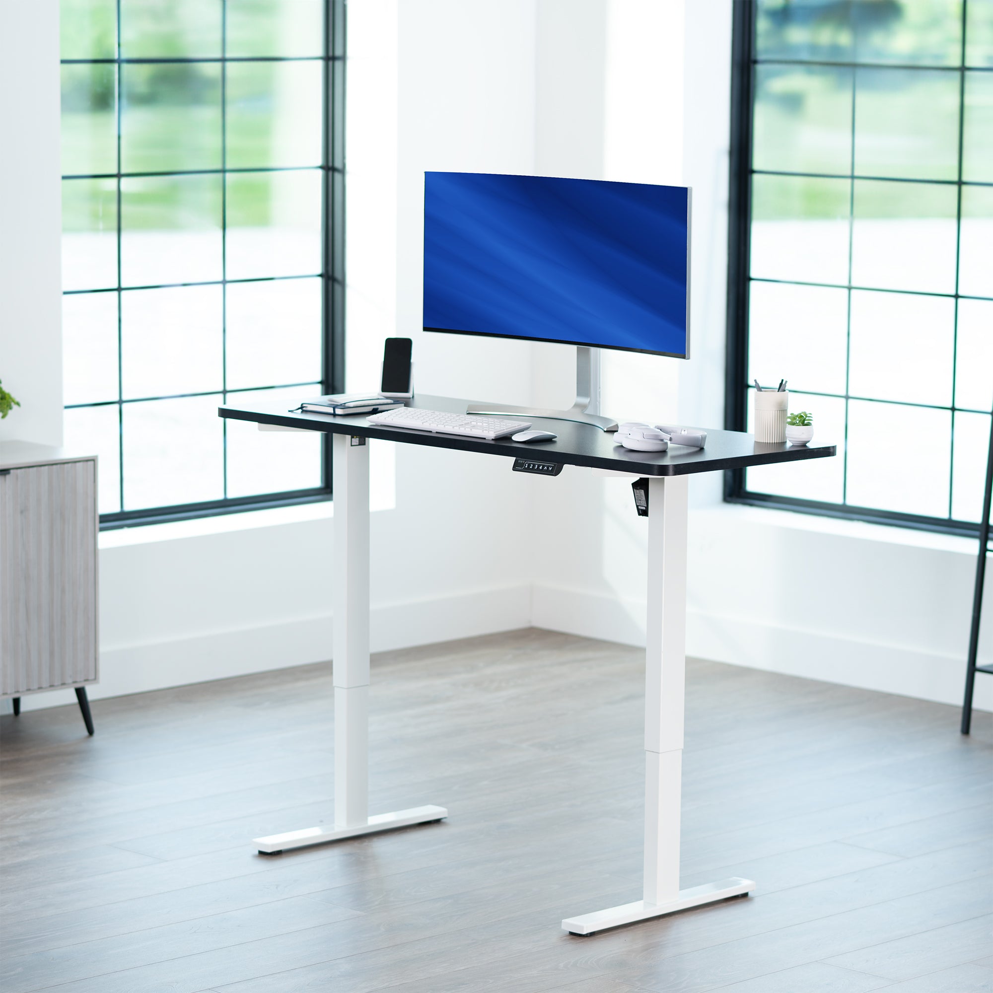 Sturdy ergonomic sit or stand active desk workstation with adjustable height using smart control panel.