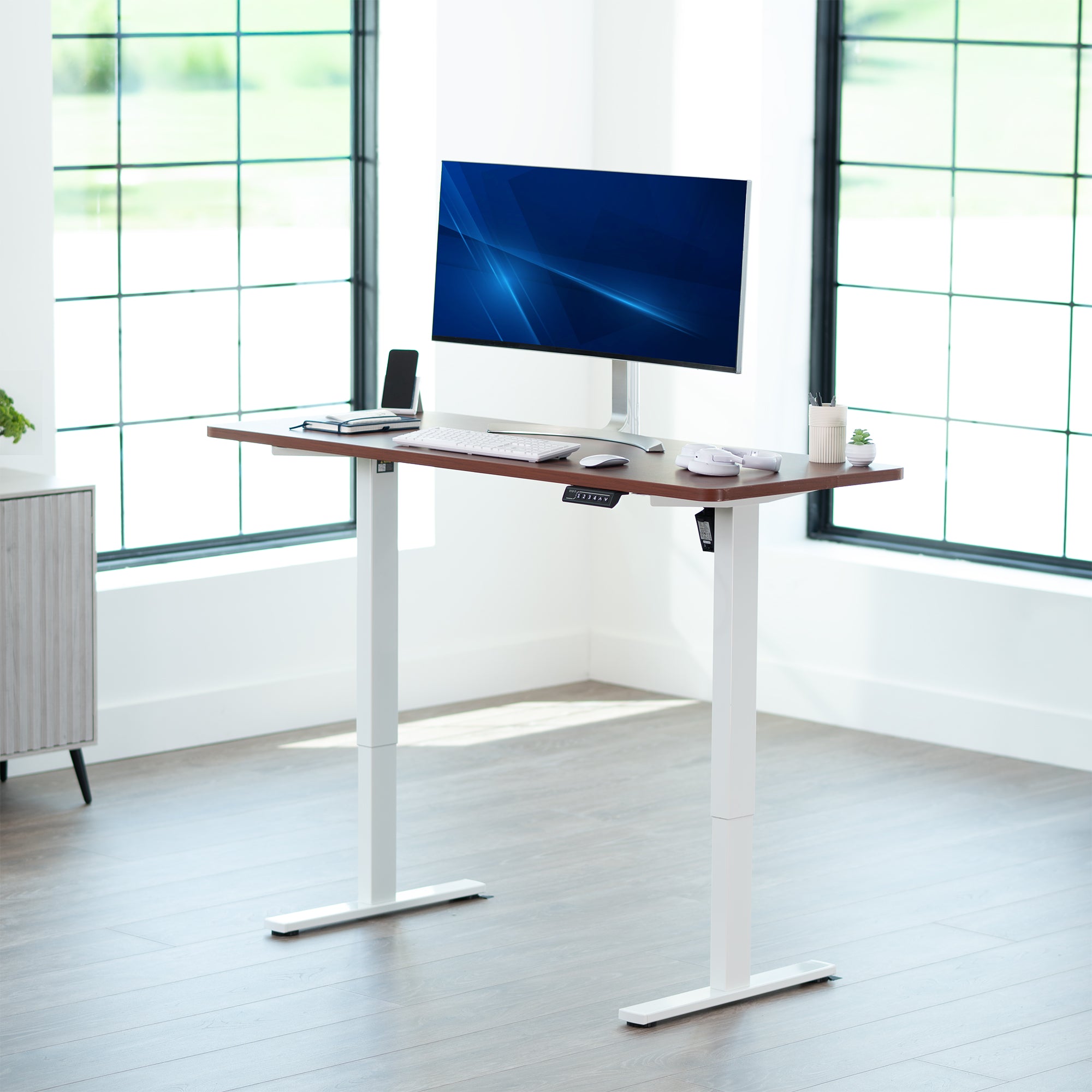Sturdy ergonomic sit or stand active desk workstation with adjustable height using smart control panel.
