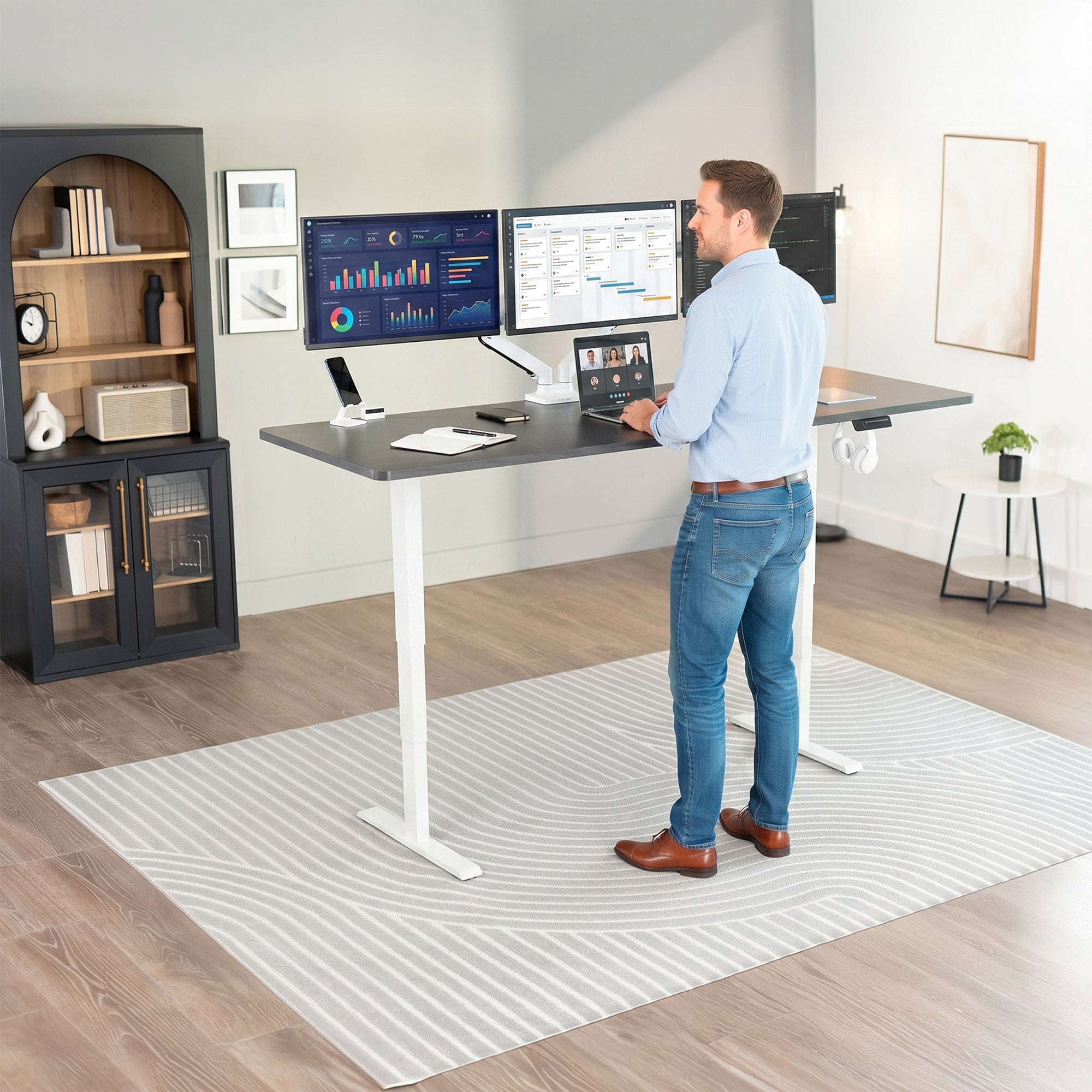 Man standing at the 2E Series - 83" x 30" Electric Desk with Touch Screen Memory Controller in office space