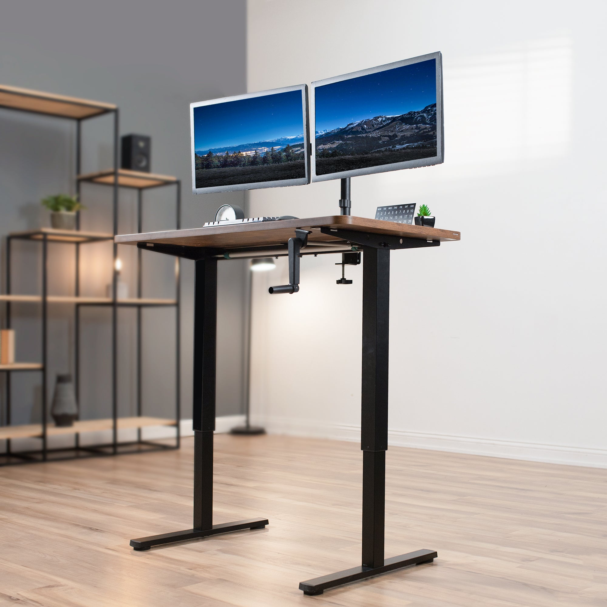 Compact steel desk frame with brown desktop and a dual monitor mount.