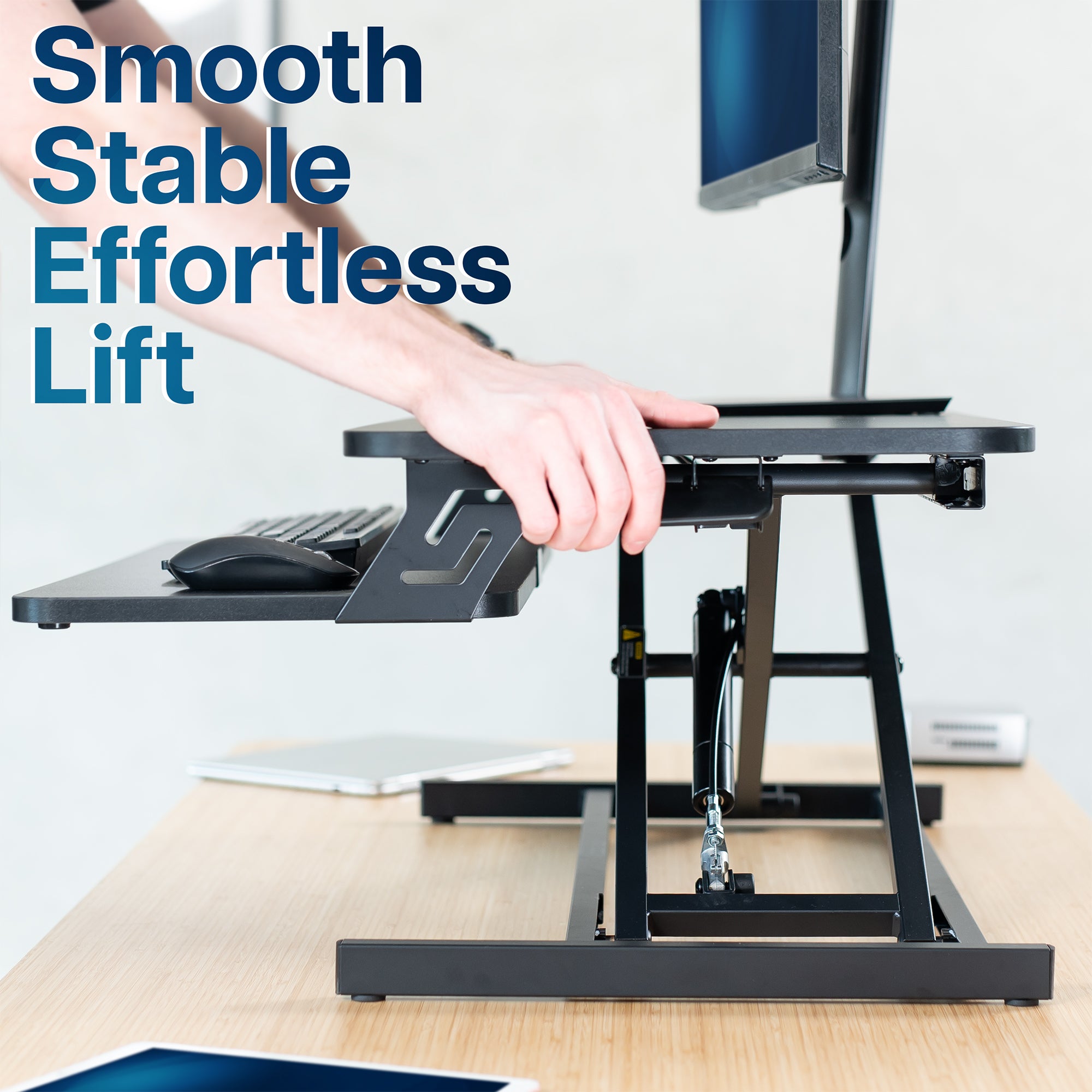 Heavy-duty height adjustable desk converter monitor riser with 2 tiers.