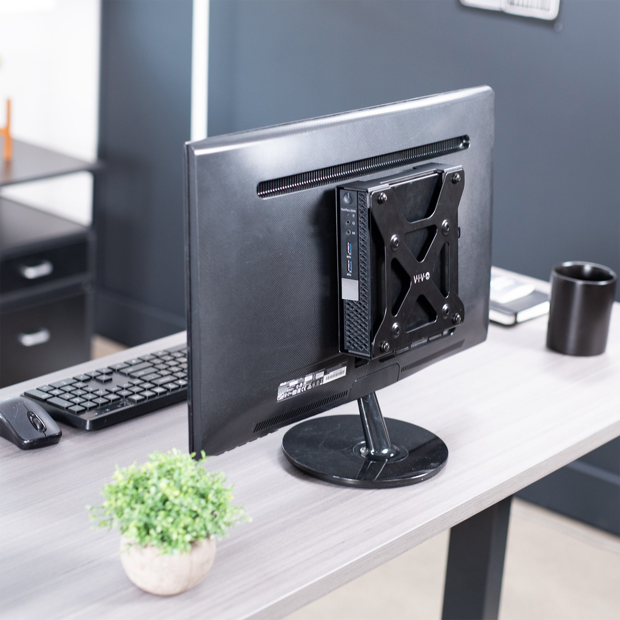 Mount Designed for Dell OptiPlex Micro on back of freestanding monitor on desk.