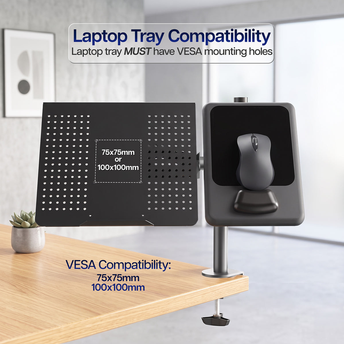 Laptop tray compatibility shown on a desk with a blurred background with text stating "Laptop tray MUST have VESA mounting holes"