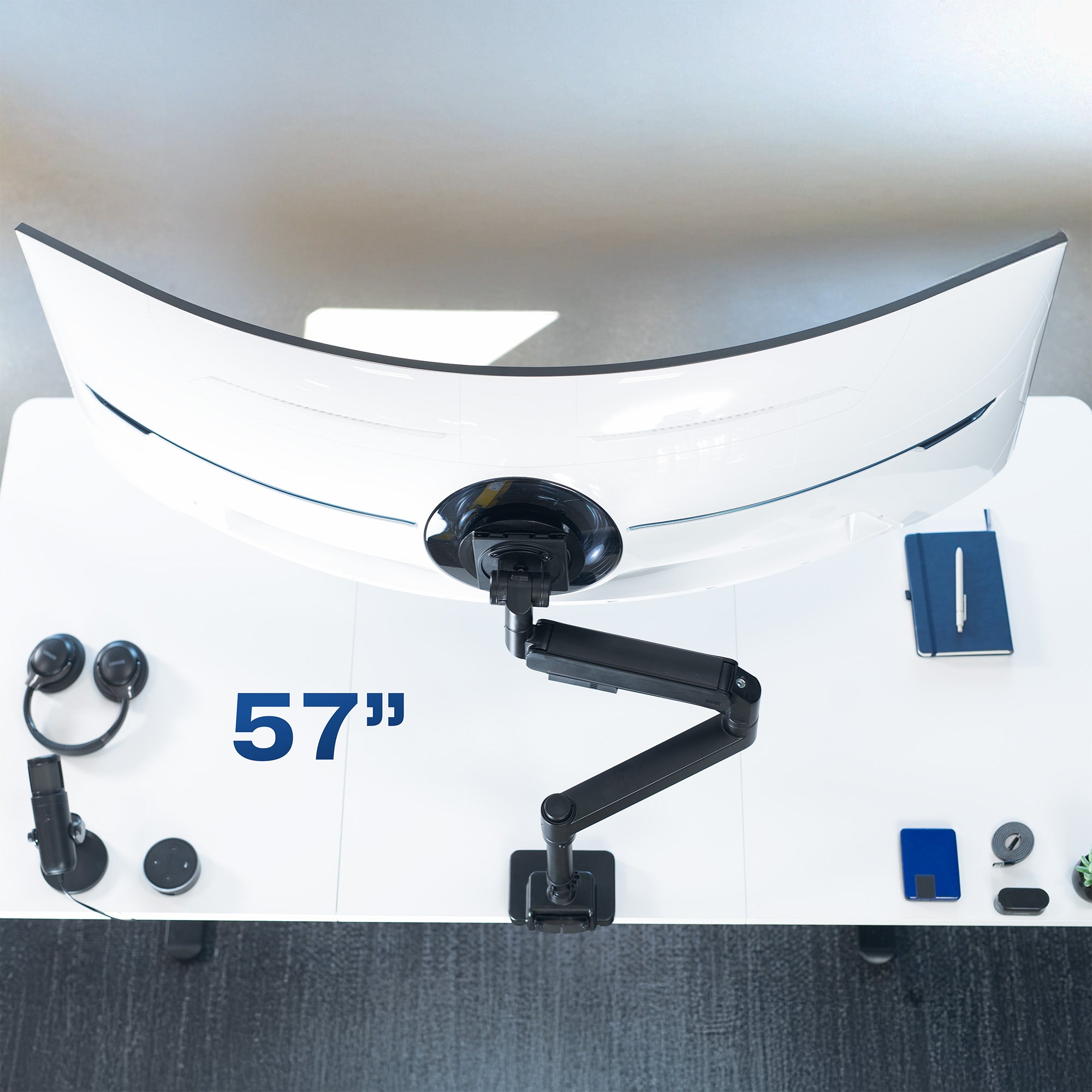 Single ultrawide monitor mounted on a pneumatic arm desk mount.