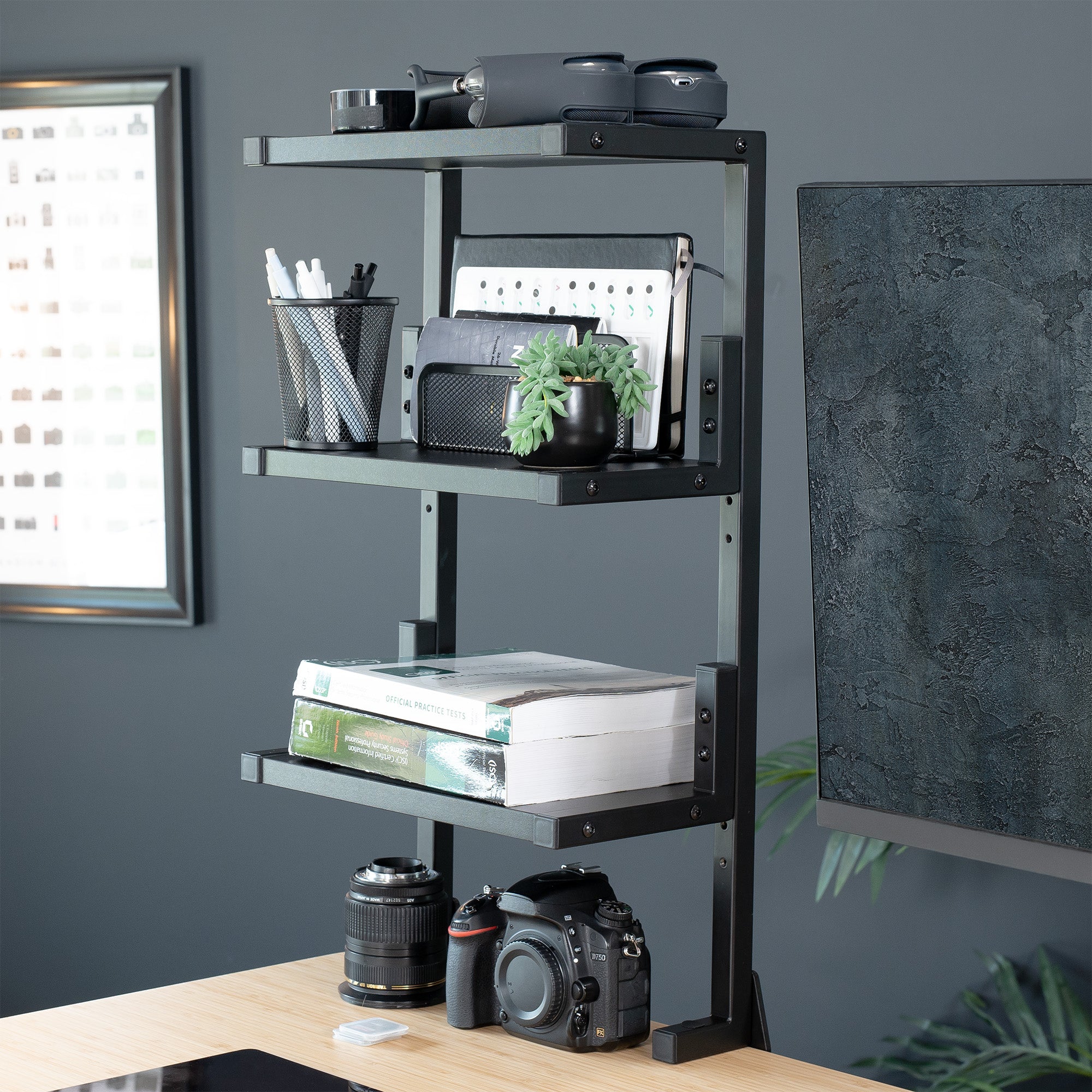 A black 13-inch clamp-on 3-tier shelving unit for desks in a modern home office.