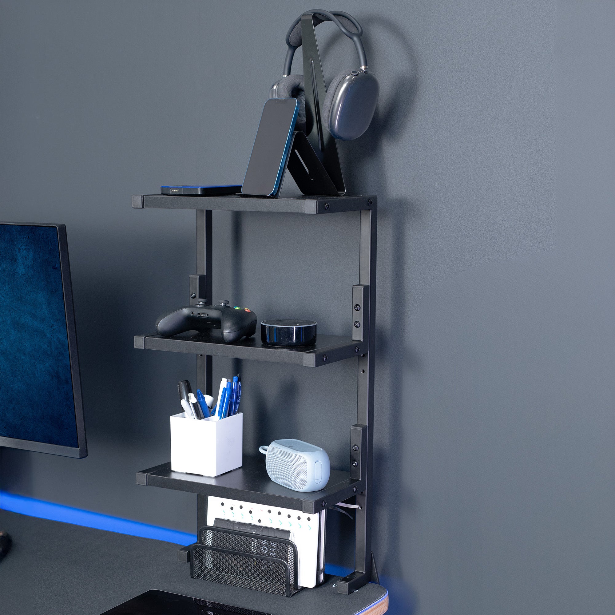 A black 13-inch clamp-on 3-tier shelving unit for desks in a gaming room.