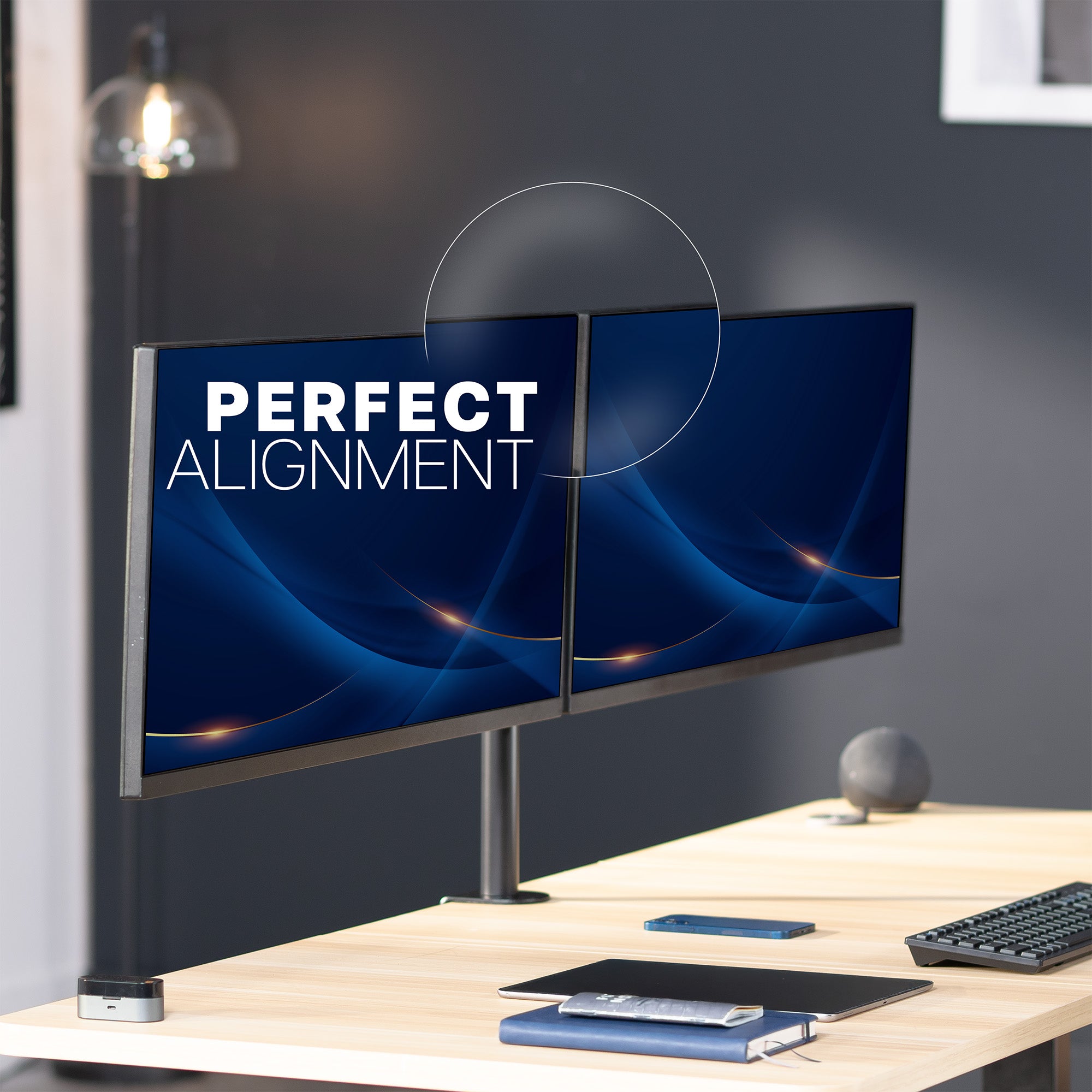 Two computer monitors on a desk with 'Perfect Alignment' text displayed.