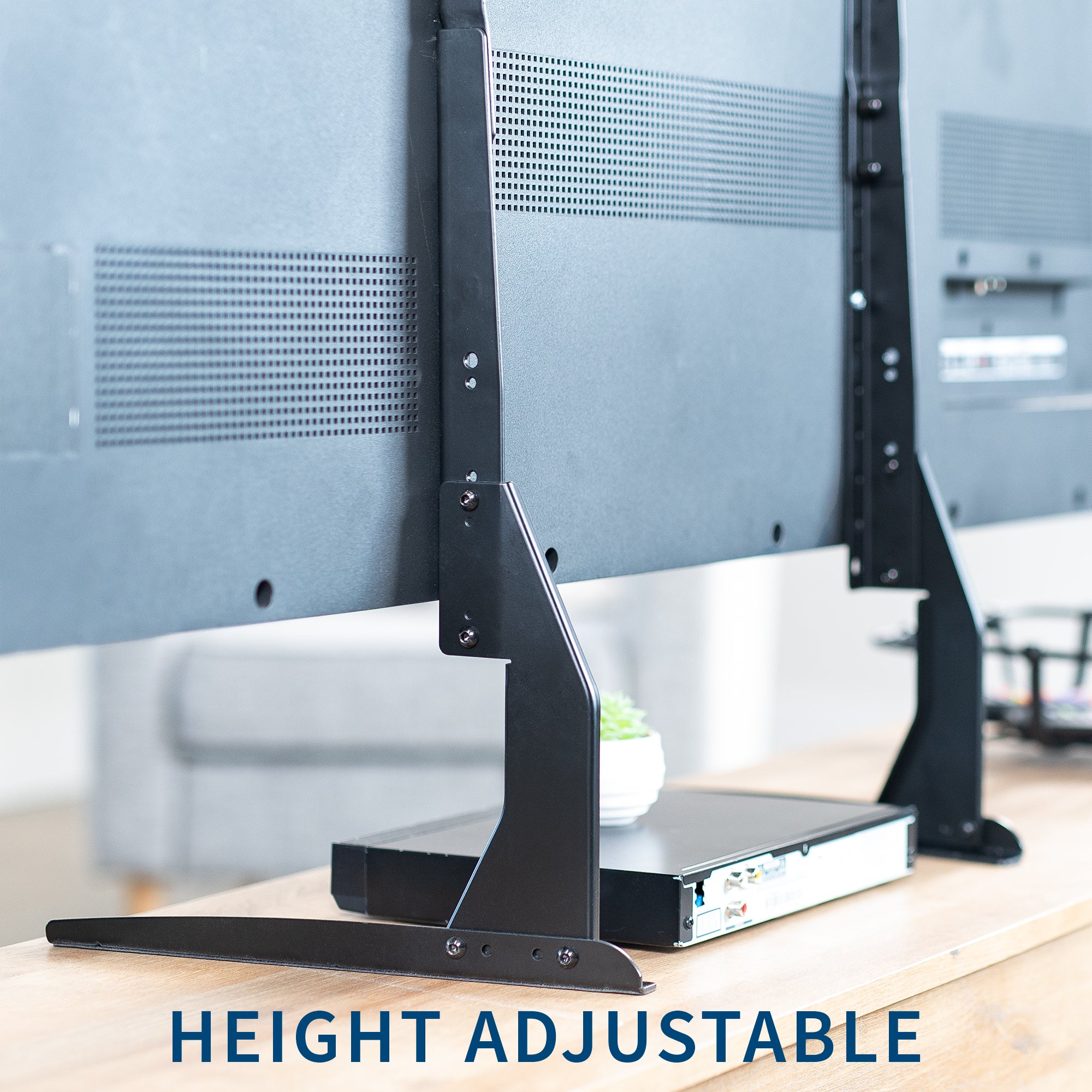 Height adjustable TV stand with a blurred office background