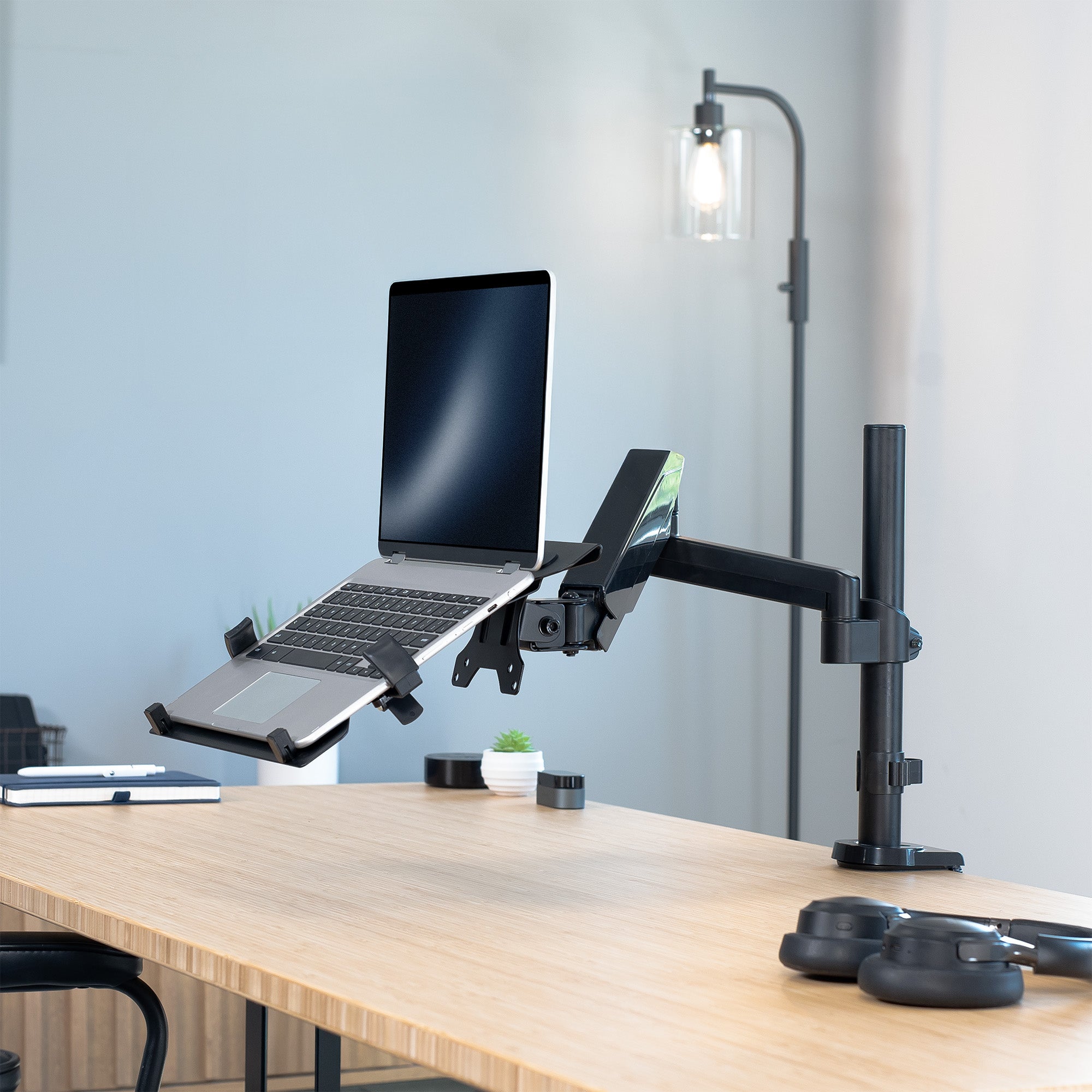 Pneumatic Arm Single Laptop Desk Mount in Office Setting.
