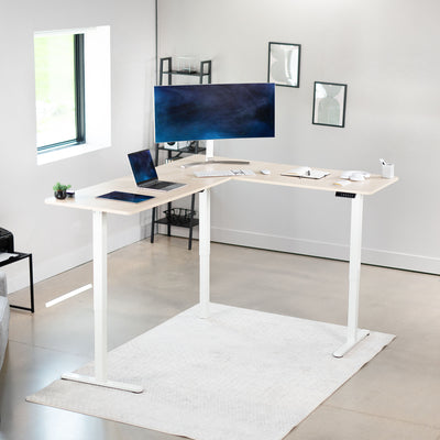 Electric heavy-duty corner desk workstation for modern office workspaces.