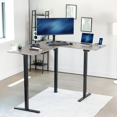 Heavy-duty electric height adjustable corner desk workstation for active sit or stand efficient workspace.