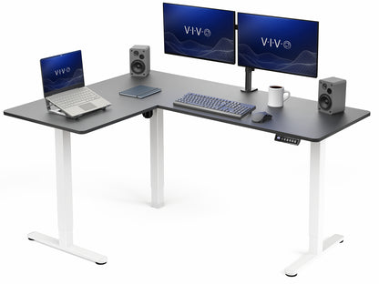 Corner L-shaped desk with computer setup including two monitors, laptop, keyboard, and speakers on a white background.