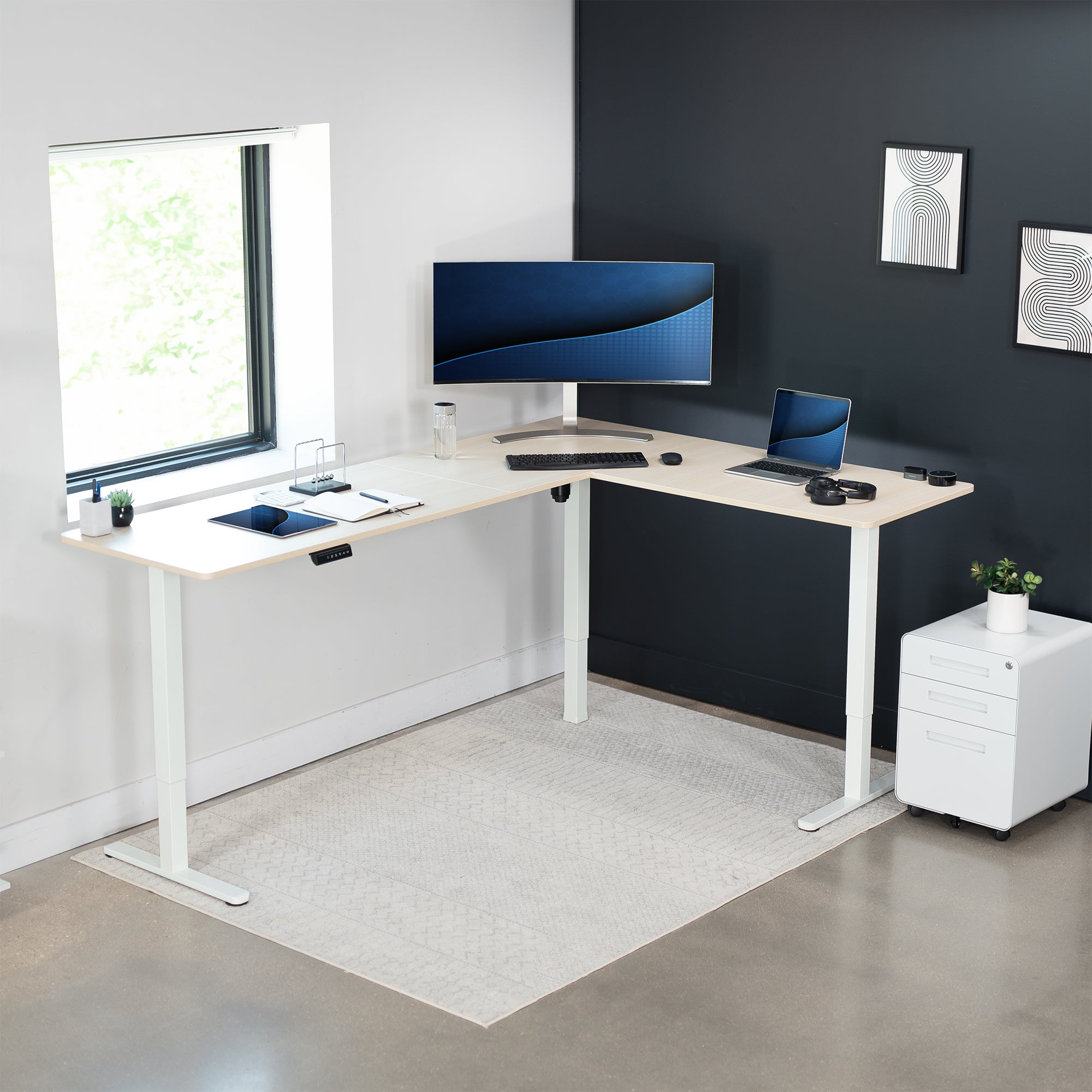 Electric heavy-duty large corner desk workstation for modern office workspaces.