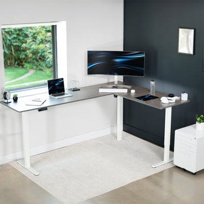 Electric heavy-duty large corner desk workstation for modern office workspaces.