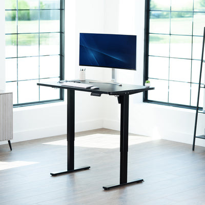 Sturdy ergonomic sit or stand active desk workstation with adjustable height using smart control panel.