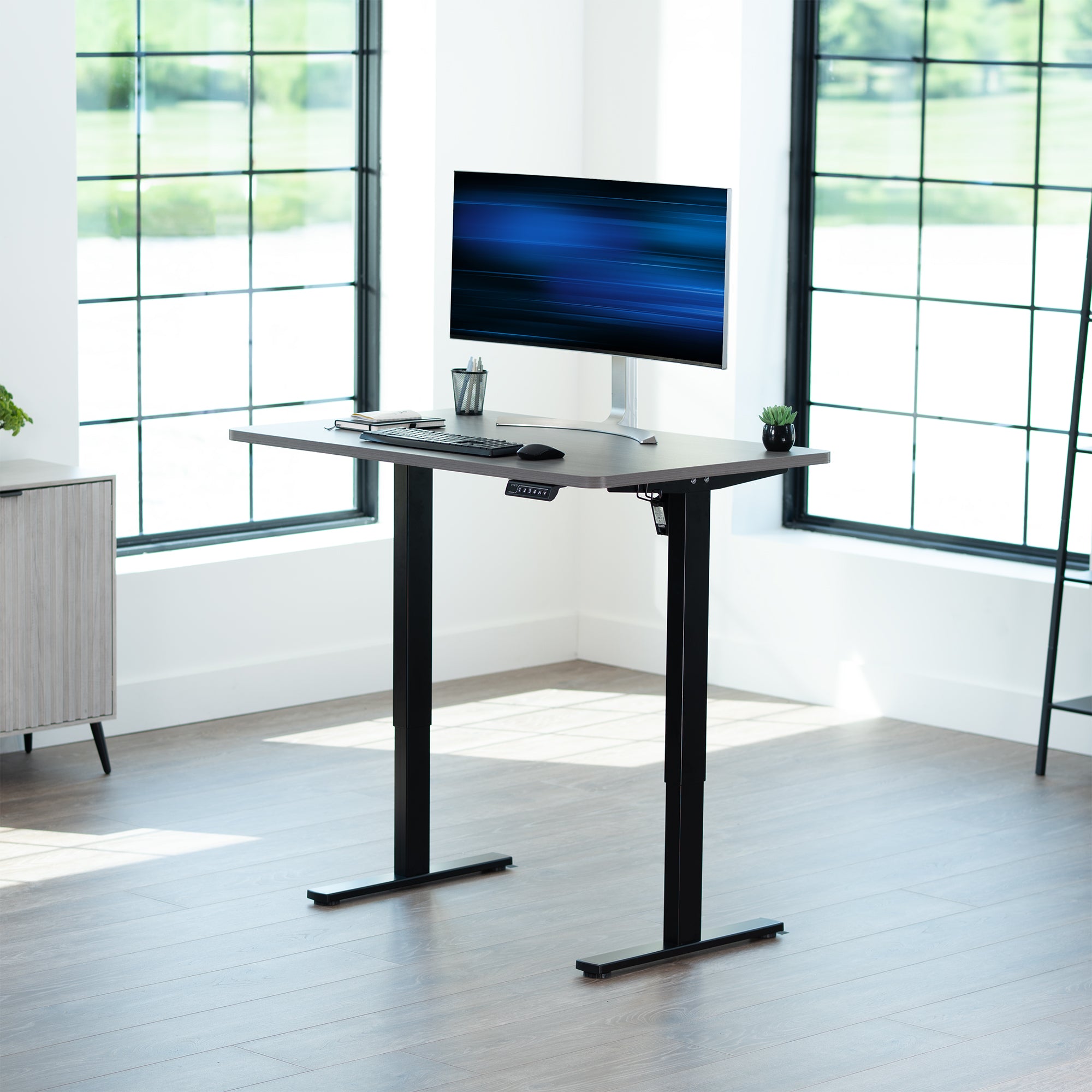 Sturdy ergonomic sit or stand active desk workstation with adjustable height using smart control panel.