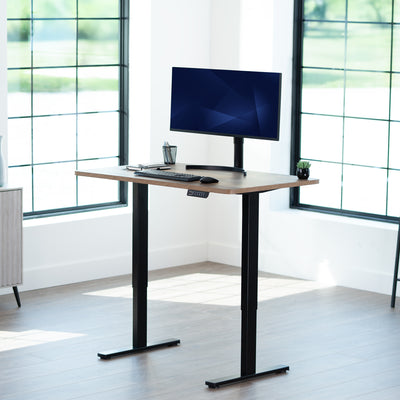 Sturdy ergonomic sit or stand active desk workstation with adjustable height using smart control panel.