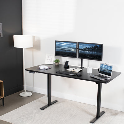 Ergonomic office space with stand-up level desk and dual monitor mount.