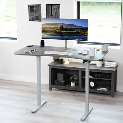 Sit to stand height adjustable electric desk with push button memory controller for ergonomic office workstation.