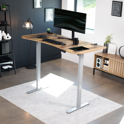 Sit to stand height adjustable electric desk with push button memory controller for ergonomic office workstation.