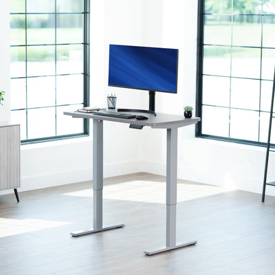Sturdy ergonomic sit or stand active desk workstation with adjustable height using smart control panel.