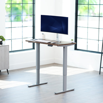 Sturdy ergonomic sit or stand active desk workstation with adjustable height using smart control panel.
