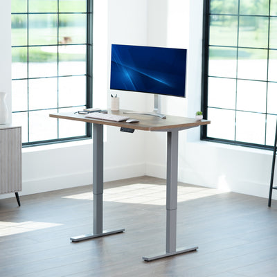 Sturdy ergonomic sit or stand active desk workstation with adjustable height using smart control panel.