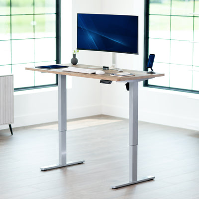 Sturdy ergonomic sit or stand active desk workstation with adjustable height using smart control panel.