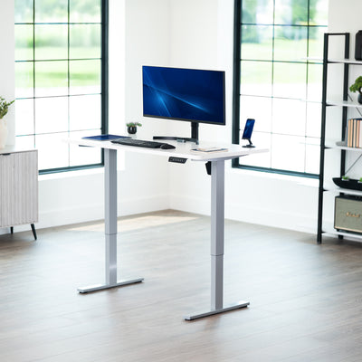Sturdy ergonomic sit or stand active desk workstation with adjustable height using smart control panel.