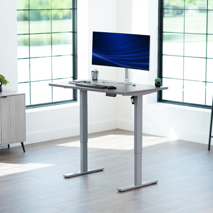 Sturdy ergonomic sit or stand active desk workstation with adjustable height using smart control panel.