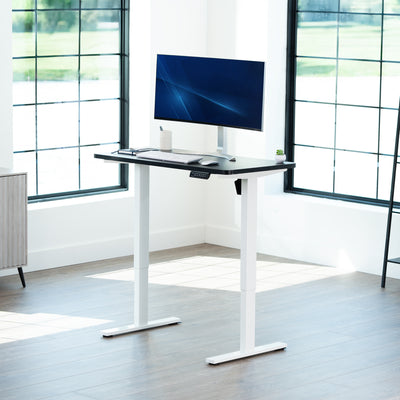 Sturdy ergonomic sit or stand active desk workstation with adjustable height using smart control panel.