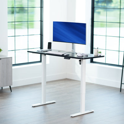 Sturdy ergonomic sit or stand active desk workstation with adjustable height using smart control panel.