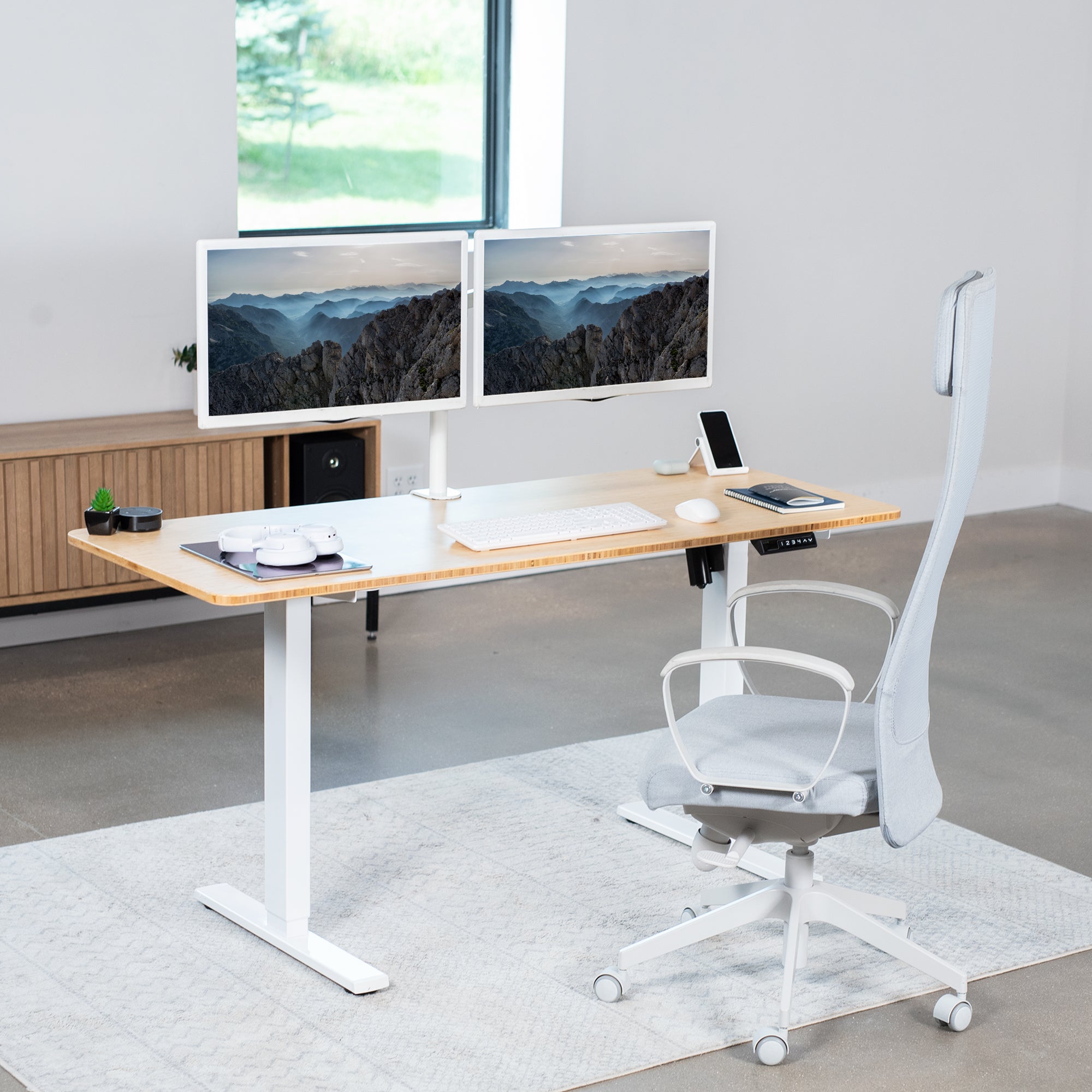 Sturdy real bamboo ergonomic sit or stand active desk workstation with adjustable height using smart control panel.