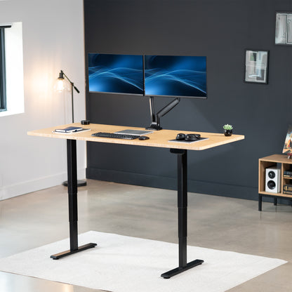 Heavy-duty electric height adjustable desktop workstation for active sit or stand efficient workspace.