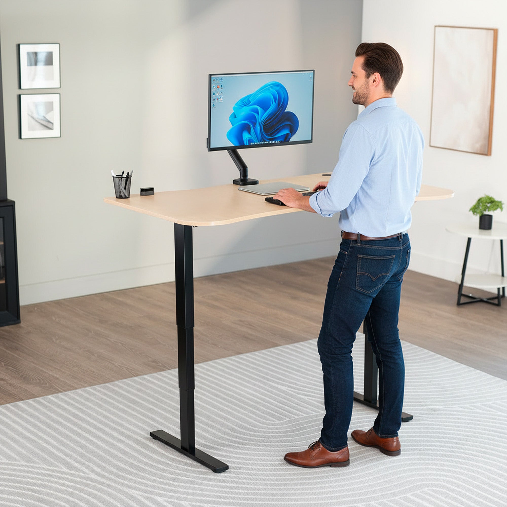 63” x 32” Electric Height Adjustable Stand Up Desk. Features a built-in power strip.