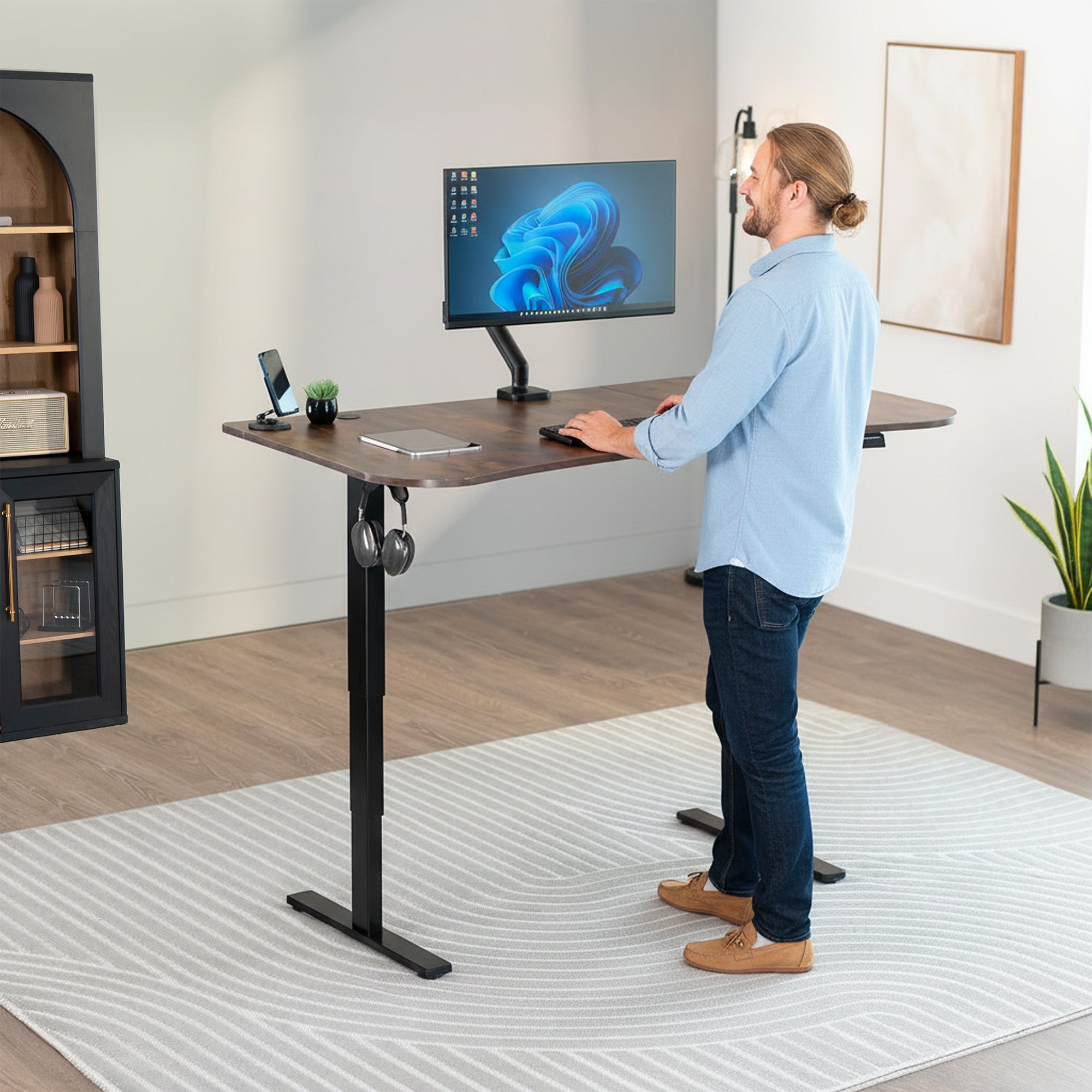 63” x 32” Electric Height Adjustable Stand Up Desk. Features a built-in power strip.
