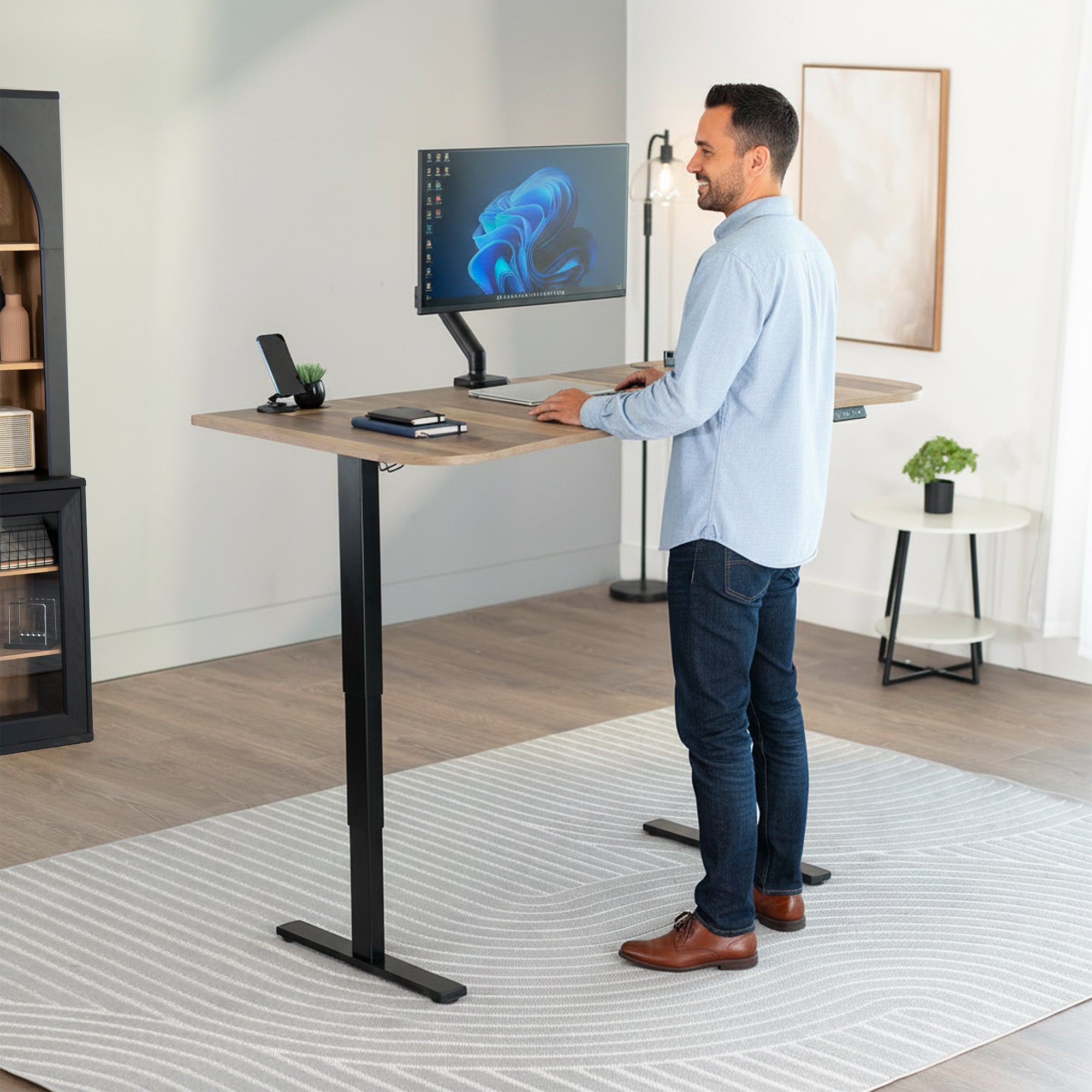 63” x 32” Electric Height Adjustable Stand Up Desk. Features a built-in power strip.