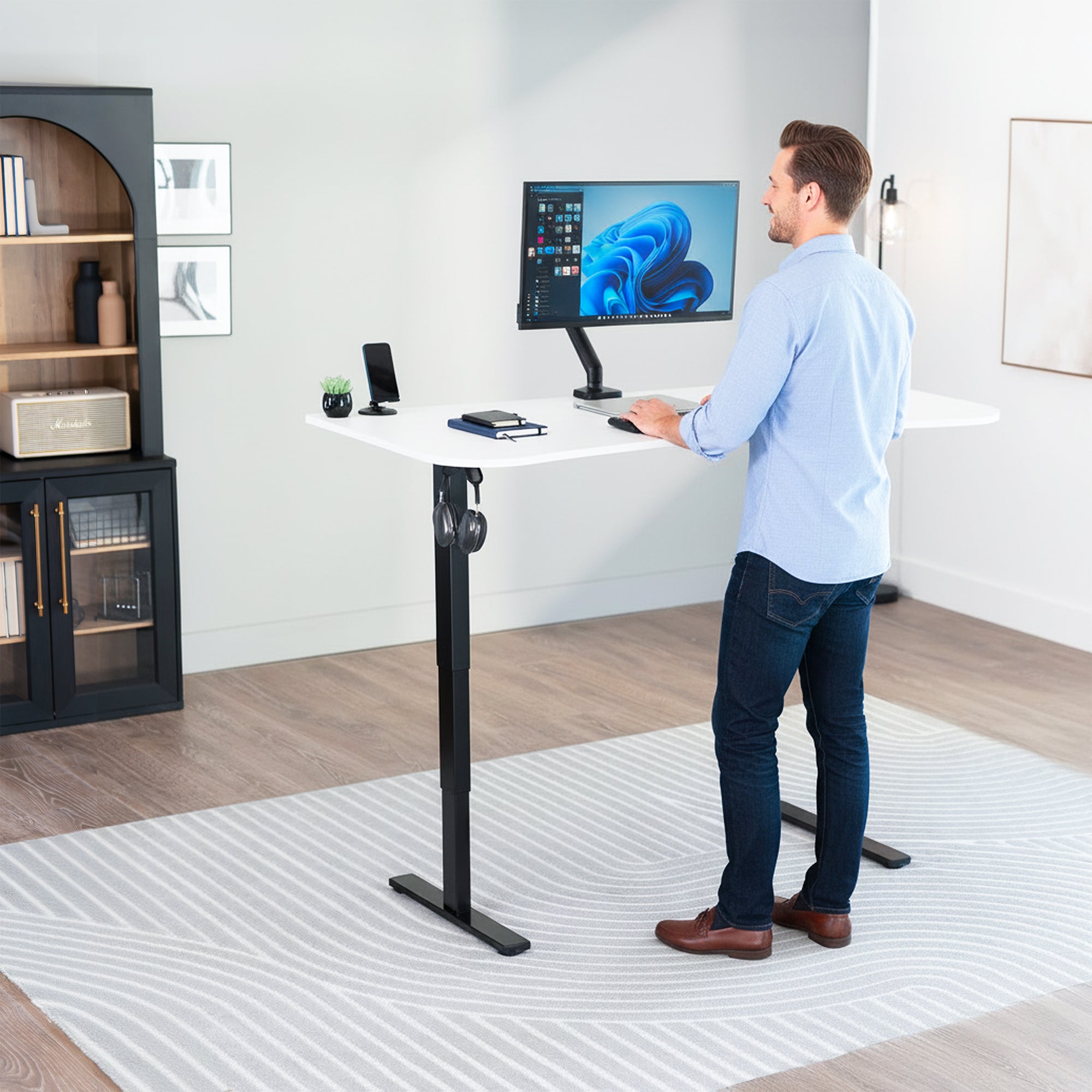 63” x 32” Electric Height Adjustable Stand Up Desk. Features a built-in power strip.